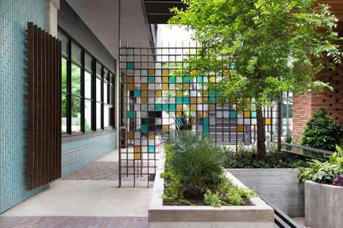 a building with a colorful mosaic wall in a courtyard at Canopy By Hilton Austin Downtown in Austin