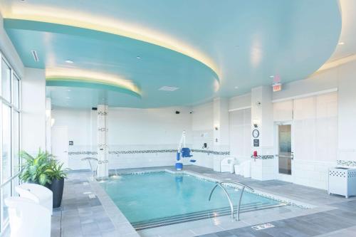 a large pool in a building with a blue ceiling at Hampton Inn & Suites Asheville Biltmore Area in Asheville