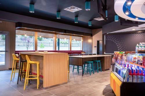 a fast food restaurant with a bar and chairs at Tru by Hilton Asheville Blue Ridge Parkway in Asheville