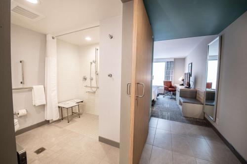 a bathroom with a walk in shower and a toilet at Hilton Garden Inn Asheville South in Asheville