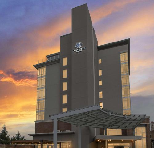 a rendering of a hotel with a sunset in the background at DoubleTree by Hilton Asheville Downtown in Asheville