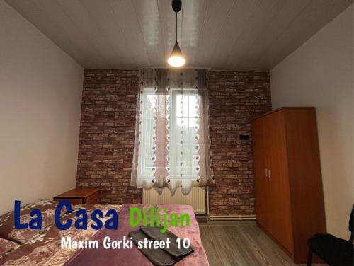 a bedroom with a brick wall and a window at Bedroom La Casa Dilijan N1 in Dilijan