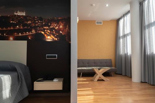 a bedroom with a bed and a view of a city at Hotel-Asador Montes Oretanos in Pulgar