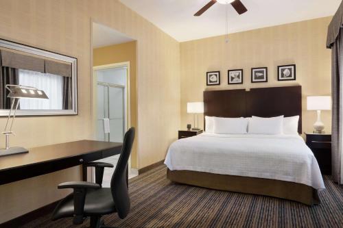 a hotel room with a bed and a desk and a computer at Homewood Suites by Hilton Newtown - Langhorne, PA in Newtown