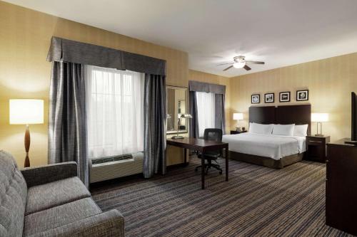 a hotel room with a bed and a couch at Homewood Suites by Hilton Newtown - Langhorne, PA in Newtown