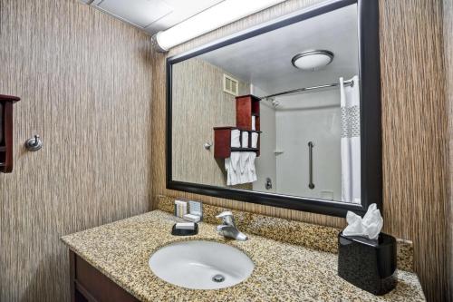 a bathroom with a sink and a large mirror at Hampton Inn Scranton at Montage Mountain in Scranton
