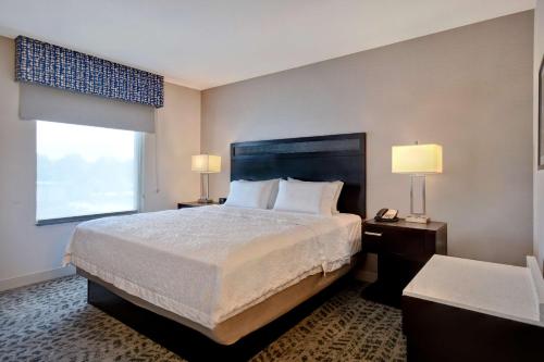a hotel room with a large bed and a window at Hampton Inn & Suites Columbia South Fort Meade Area in Columbia