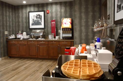 a kitchen with a table with a waffle at Hampton Inn & Suites By Hilton Baltimore/Aberdeen, Md in Aberdeen