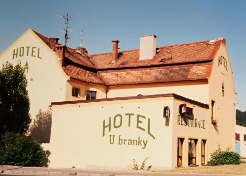 a building with a hotel sign on the side of it at Hotel U Branky in Stříbro