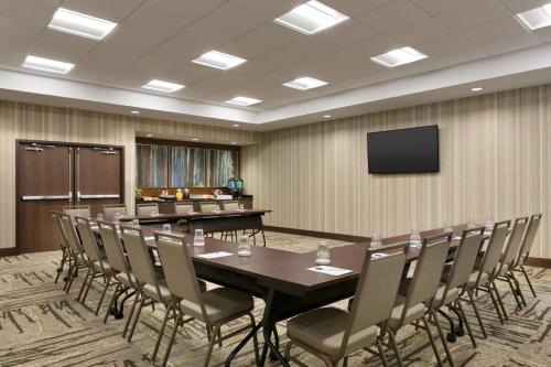 a conference room with a table and chairs and a television at Homewood Suites By Hilton Hartford Manchester in Manchester