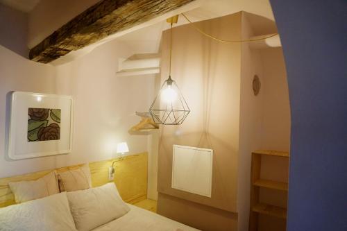 a bedroom with a bed and a pendant light at VOLKSinn in Vienna