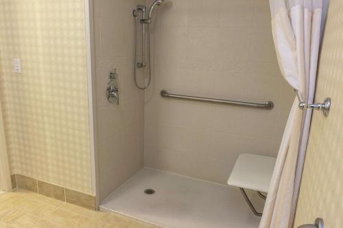 a shower in a bathroom with a shower curtain at Hilton Garden Inn Bangor in Bangor