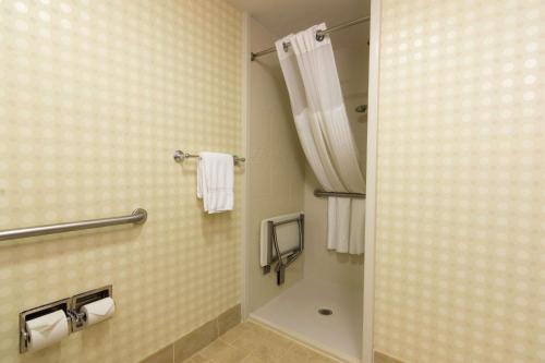 a bathroom with a shower and a shower curtain at Hilton Garden Inn Bangor in Bangor