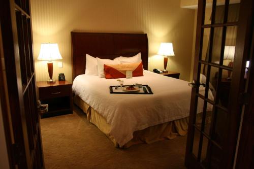 a hotel room with a bed with a tray of food on it at Hilton Garden Inn Bangor in Bangor