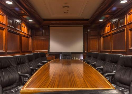 a conference room with a wooden table and chairs at Hilton Garden Inn Bangor in Bangor