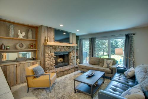 a living room with a couch and a fireplace at Walk to Beaver Creek Shuttle! Avon Condo with Deck in Avon