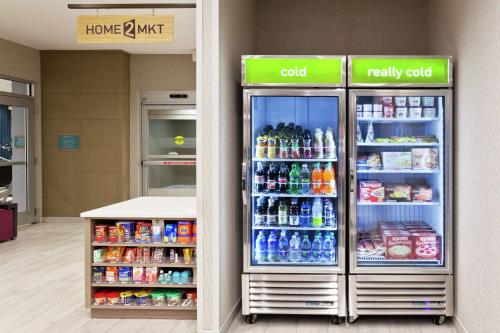 a store with two refrigerators with soda and drinks at Home2 Suites By Hilton Birmingham Colonnade in Birmingham