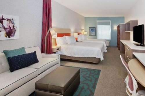 a hotel room with a bed and a couch at Home2 Suites By Hilton Birmingham Colonnade in Birmingham