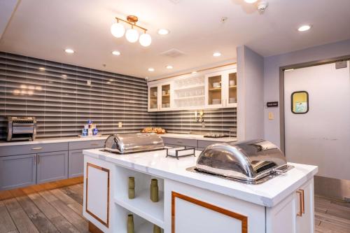 a large kitchen with blue cabinets and a white counter top at Homewood Suites by Hilton Birmingham-SW-Riverchase-Galleria in Hoover