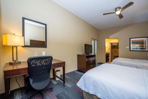 a hotel room with a bed and a desk with a chair at Homewood Suites by Hilton Birmingham-SW-Riverchase-Galleria in Hoover