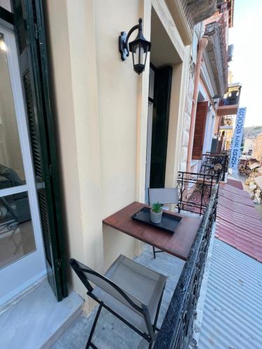 a table and chair on the balcony of a building at Domus Bettolo in Chania Town