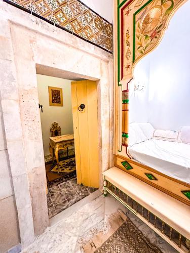 a bedroom with a bed and a mirror in a room at Dar Badiaa in Sousse