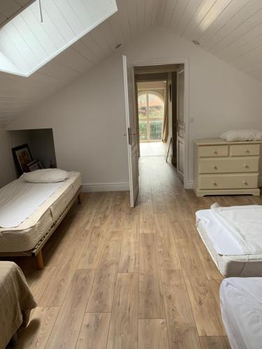 a attic bedroom with two beds and a skylight at maison bleue in Biscarrosse