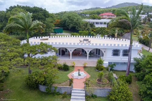an aerial view of a white house with trees at Castles In Paradise Villa Resort in Vieux Fort