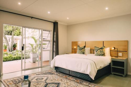 a bedroom with a large bed and a balcony at Devereux Lodge in East London