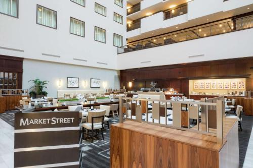 a restaurant with tables and chairs in a building at Hilton Nashville Downtown in Nashville