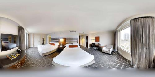 a hotel room with two beds and a large window at Hilton Nashville Downtown in Nashville