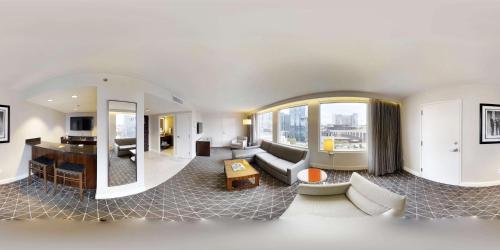 a living room filled with furniture and a large window at Hilton Nashville Downtown in Nashville