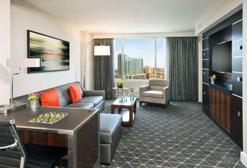 a living room with a couch and a table in a hotel room at Hilton Nashville Downtown in Nashville