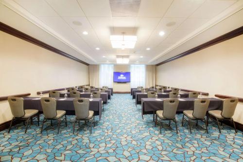 a large room with rows of chairs and a projection screen at Hilton Nashville Downtown in Nashville