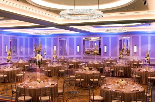 a ballroom with tables and chairs in a room with purple walls at Hilton Nashville Downtown in Nashville
