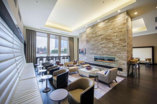 a lobby with a fireplace and a waiting room with chairs at Hilton Nashville Downtown in Nashville