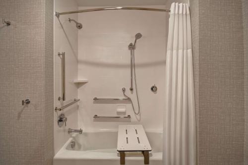 a bathroom with a shower and a bath tub with a shower curtain at Hampton Inn Pleasant View in Pleasant View