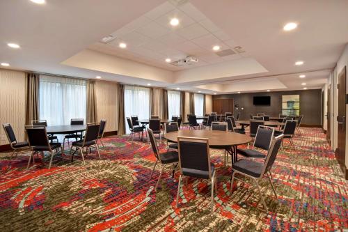 a conference room with tables and chairs on a rug at Hampton Inn Pleasant View in Pleasant View