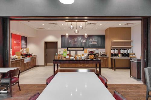 a dining room and kitchen with a table and chairs at Hampton Inn & Suites by Hilton Nashville North Skyline in Nashville