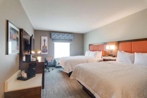 a hotel room with two beds and a window at Hampton Inn & Suites by Hilton Nashville North Skyline in Nashville