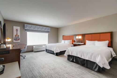 a hotel room with two beds and a desk at Hampton Inn & Suites by Hilton Nashville North Skyline in Nashville