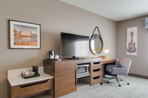 a hotel room with a desk with a television and a chair at Hampton Inn & Suites by Hilton Nashville North Skyline in Nashville