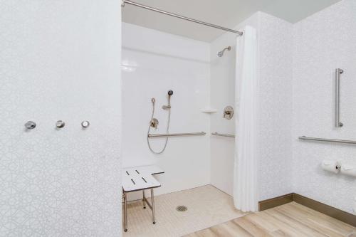 a white bathroom with a shower and a bench at Hampton Inn & Suites by Hilton Nashville North Skyline in Nashville