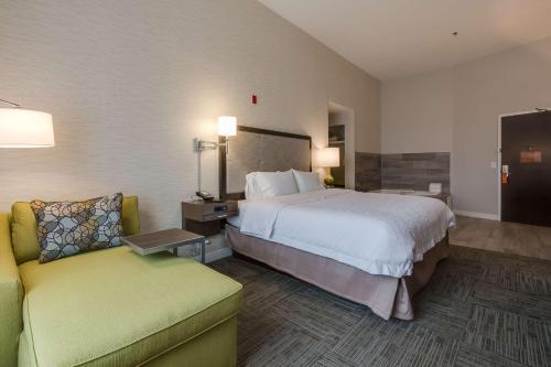 a hotel room with a bed and a couch at Hampton Inn White House in White House