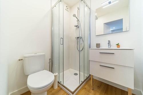 a white bathroom with a toilet and a shower at Quiet & Comfortable Studio Near Lyon Sainte-Foy-lès-Lyon in Sainte-Foy-lès-Lyon
