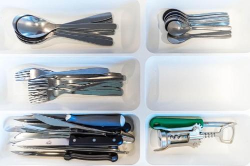 four plastic utensils in a refrigerator drawer at Quiet & Comfortable Studio Near Lyon Sainte-Foy-lès-Lyon in Sainte-Foy-lès-Lyon