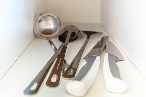 a group of utensils sitting on top of a drawer at Quiet & Comfortable Studio Near Lyon Sainte-Foy-lès-Lyon in Sainte-Foy-lès-Lyon