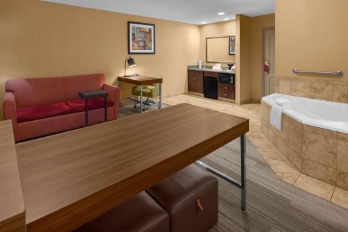 a living room with a couch and a bath tub at Hampton Inn & Suites Banning/Beaumont in Banning