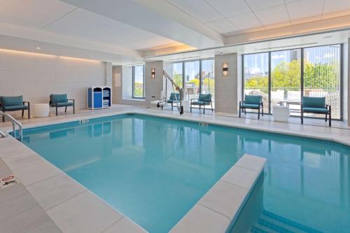 a pool with blue water in a hotel room at Hilton Garden Inn Boston Brookline, Ma in Brookline
