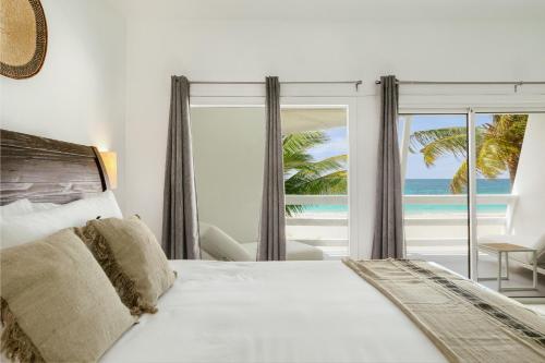 Postel nebo postele na pokoji v ubytování CocoVaa Beach Boutique Hotel